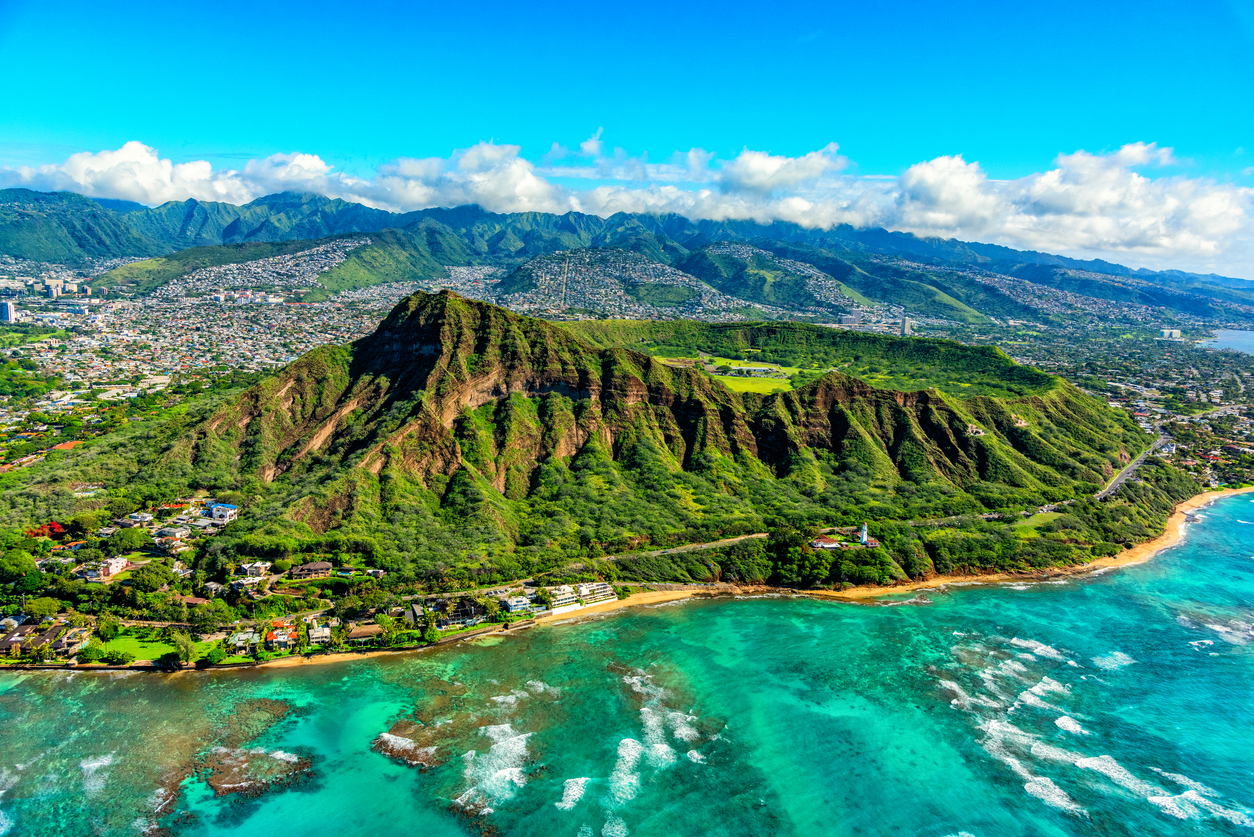 Wide angle aerial view of the majestic Diamond Head volcanic crater towering over the suburbs of Honolulu, Hawaii.